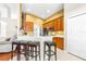 Kitchen featuring wooden cabinets, stainless steel appliances and breakfast bar at 8814 N River Rd, Tampa, FL 33635