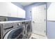 Modern laundry room with front load washer and dryer, offering convenience and efficiency at 8814 N River Rd, Tampa, FL 33635