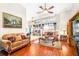 Cozy living room featuring comfortable seating, a ceiling fan, and access to a dining area at 8814 N River Rd, Tampa, FL 33635