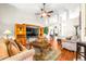This open living room includes wood floors, a ceiling fan and access to other rooms at 8814 N River Rd, Tampa, FL 33635