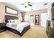 A bright, well-appointed main bedroom with neutral carpet and an elegant dark wood dresser at 8814 N River Rd, Tampa, FL 33635