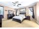 A serene main bedroom features soft, carpeted floors, decorative windows and a plush, comfortable bed at 8814 N River Rd, Tampa, FL 33635
