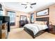 Main bedroom with neutral carpeting, dark wood furnishings and ensuite bath at 8814 N River Rd, Tampa, FL 33635