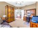 Office area with a large wardrobe for storage, complemented by a spacious workspace at 8814 N River Rd, Tampa, FL 33635