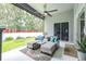 Comfortable screened patio with ample seating, ceiling fan, overlooking the backyard at 8814 N River Rd, Tampa, FL 33635