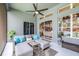 Stylish screened patio with comfortable seating, ceiling fan, and sunshades for privacy at 8814 N River Rd, Tampa, FL 33635