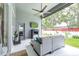 Relaxing screened patio with ceiling fan, outdoor seating, and tv for entertainment at 8814 N River Rd, Tampa, FL 33635