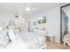 Light, airy bedroom with bright decor, beach mural TV, and balcony at 9525 Blind Pass Rd # 505, St Pete Beach, FL 33706