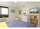 Charming bedroom with bright accents, window and bookshelf at 9525 Blind Pass Rd # 505, St Pete Beach, FL 33706