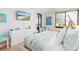 Beach themed bedroom features white dresser and balcony access at 9525 Blind Pass Rd # 505, St Pete Beach, FL 33706
