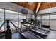 Resident gym with treadmills, exercise equipment, and views of the pool at 9525 Blind Pass Rd # 505, St Pete Beach, FL 33706
