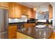Bright kitchen features wooden cabinets, granite countertops, stainless steel appliances, and track lighting at 9525 Blind Pass Rd # 505, St Pete Beach, FL 33706