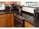 Kitchen view showcases modern appliances, dark counters, and wood cabinetry at 9525 Blind Pass Rd # 505, St Pete Beach, FL 33706