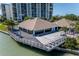 Lounge deck with tables, chairs, and sun loungers next to the building at 9525 Blind Pass Rd # 505, St Pete Beach, FL 33706
