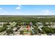 Aerial view of the home in a suburban neighborhood, close to wooded areas at 10452 Elgin Blvd, Spring Hill, FL 34608