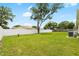 Expansive fenced back yard with mature shade trees and green grass at 10452 Elgin Blvd, Spring Hill, FL 34608