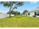 Lush backyard with mature trees, white fence, and ample space for outdoor activities at 10452 Elgin Blvd, Spring Hill, FL 34608