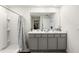 Well-lit bathroom with dual vanity, modern fixtures, and walk-in shower at 10452 Elgin Blvd, Spring Hill, FL 34608
