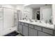 Well-lit bathroom with dual vanity, modern fixtures, and walk-in shower at 10452 Elgin Blvd, Spring Hill, FL 34608