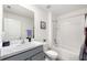 Clean, well-lit bathroom with a shower-tub combo, marble countertop, and sleek fixtures at 10452 Elgin Blvd, Spring Hill, FL 34608