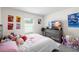 Inviting bedroom with soft carpet, a dresser with a TV, and plenty of stuffed animals at 10452 Elgin Blvd, Spring Hill, FL 34608