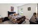 Vibrant bedroom featuring sports-themed decor and a large window for natural light at 10452 Elgin Blvd, Spring Hill, FL 34608