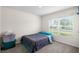 Cozy bedroom with large window and plush gray carpet providing ample natural light at 10452 Elgin Blvd, Spring Hill, FL 34608