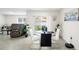 Cozy dining area with modern table, chairs, and view of the living room and backyard at 10452 Elgin Blvd, Spring Hill, FL 34608