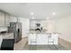 Bright kitchen with island featuring granite countertops and seating, plus stainless steel appliances at 10452 Elgin Blvd, Spring Hill, FL 34608
