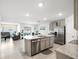 Open-concept kitchen with granite countertops, stainless steel appliances, and a large island at 10452 Elgin Blvd, Spring Hill, FL 34608
