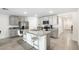 Bright kitchen with large island featuring granite countertops and seating, plus stainless steel appliances at 10452 Elgin Blvd, Spring Hill, FL 34608