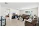 Inviting living room is complete with neutral color palette, tile floors, and comfortable seating at 10452 Elgin Blvd, Spring Hill, FL 34608