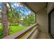 View from the balcony overlooking a lush green backyard, mature trees and blue skies at 1111 N Bayshore Blvd # E10, Clearwater, FL 33759
