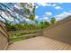 Balcony overlooking lush landscaping and a sunny, blue sky view in a beautiful neighborhood at 1111 N Bayshore Blvd # E10, Clearwater, FL 33759