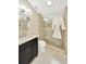 Bathroom featuring a dark wood vanity, tiled shower and skylight at 1111 N Bayshore Blvd # E10, Clearwater, FL 33759