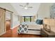 Bedroom with vaulted ceiling, barn door, hardwood flooring, and large windows with a view at 1111 N Bayshore Blvd # E10, Clearwater, FL 33759