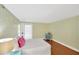 Bright bedroom with hardwood floors, string lights, and a door to the outside at 1111 N Bayshore Blvd # E10, Clearwater, FL 33759