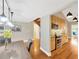 Dining room with hardwood flooring, stairs, open kitchen, and modern pendant lighting at 1111 N Bayshore Blvd # E10, Clearwater, FL 33759