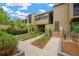 Inviting townhouse exterior with mature landscaping, walkway, and steps to the front door at 1111 N Bayshore Blvd # E10, Clearwater, FL 33759