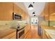 Bright kitchen featuring stainless steel appliances, tiled backsplash, and wood cabinets at 1111 N Bayshore Blvd # E10, Clearwater, FL 33759