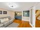 Cozy living room with wet bar, mirrored wall, and hardwood flooring at 1111 N Bayshore Blvd # E10, Clearwater, FL 33759