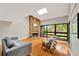 Stylish living room with stone fireplace, skylight, and access to a private outdoor balcony at 1111 N Bayshore Blvd # E10, Clearwater, FL 33759