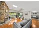 Bright living room featuring a stone fireplace, skylight, and sliding glass doors to the balcony at 1111 N Bayshore Blvd # E10, Clearwater, FL 33759