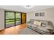 Relaxing living room boasts a leather couch, sliding doors to balcony, and area rug at 1111 N Bayshore Blvd # E10, Clearwater, FL 33759