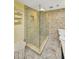 Shower stall features stonework tile surround, and frameless glass enclosure at 1111 N Bayshore Blvd # E10, Clearwater, FL 33759