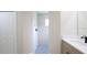 Bathroom featuring tiled shower, vanity with a sink, and linen closet at 11483 Poorwill Ave, Brooksville, FL 34614
