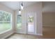 Bright dining area with stylish pendant lighting and views of the serene backyard at 11483 Poorwill Ave, Brooksville, FL 34614