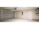 Spacious garage with concrete flooring, an insulated door and a utilitarian aesthetic at 11483 Poorwill Ave, Brooksville, FL 34614