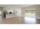Open-concept kitchen with stainless appliances and expansive views of the backyard and patio at 11483 Poorwill Ave, Brooksville, FL 34614