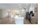 Modern kitchen with white cabinets, stainless steel appliances, and an open layout to the living area at 11483 Poorwill Ave, Brooksville, FL 34614